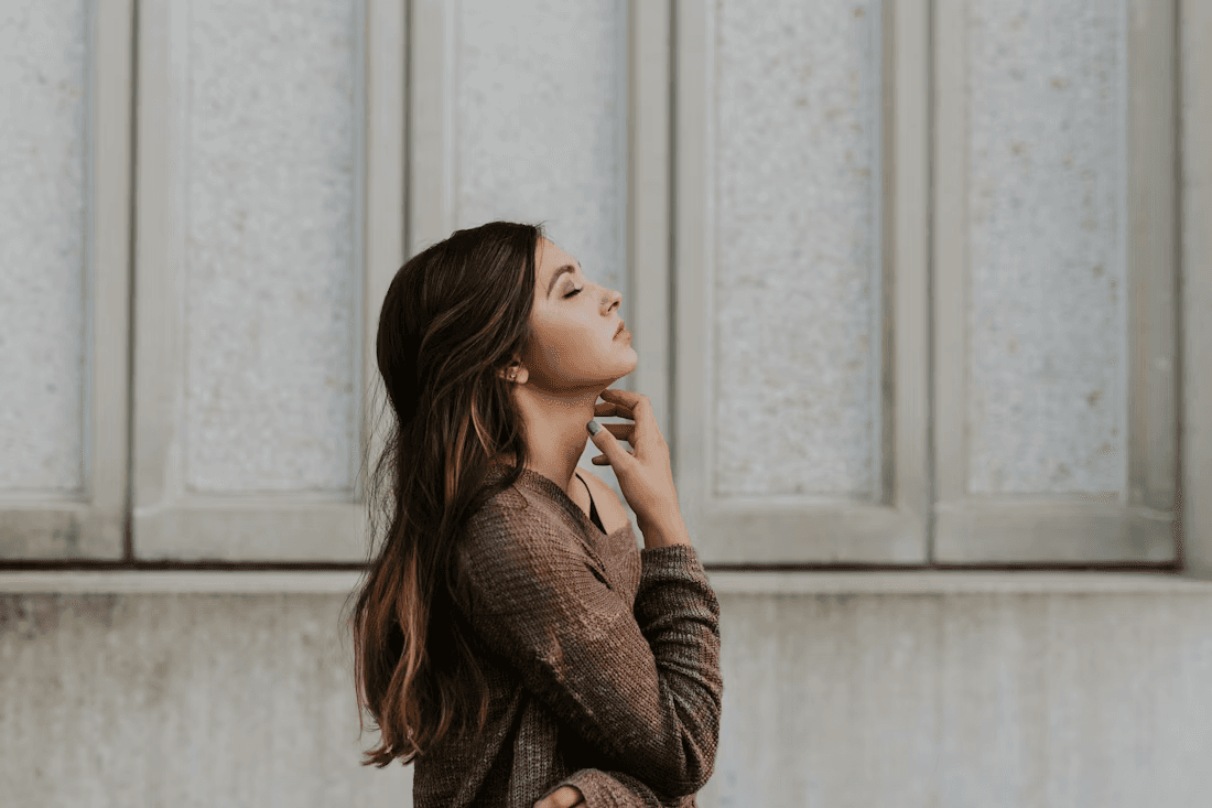 A woman looking thoughtfully out of a window