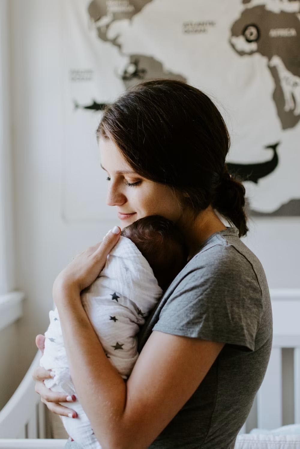 A mother holding her newborn tenderly